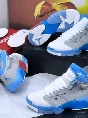 A pair of white and red Air Jordan 9 high-top sneakers on display, perfect for sneakerheads and fashion enthusiasts in Nigeria.