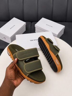 Premium grey and orange sandals with white shoe boxes on a table | Tconcorde
